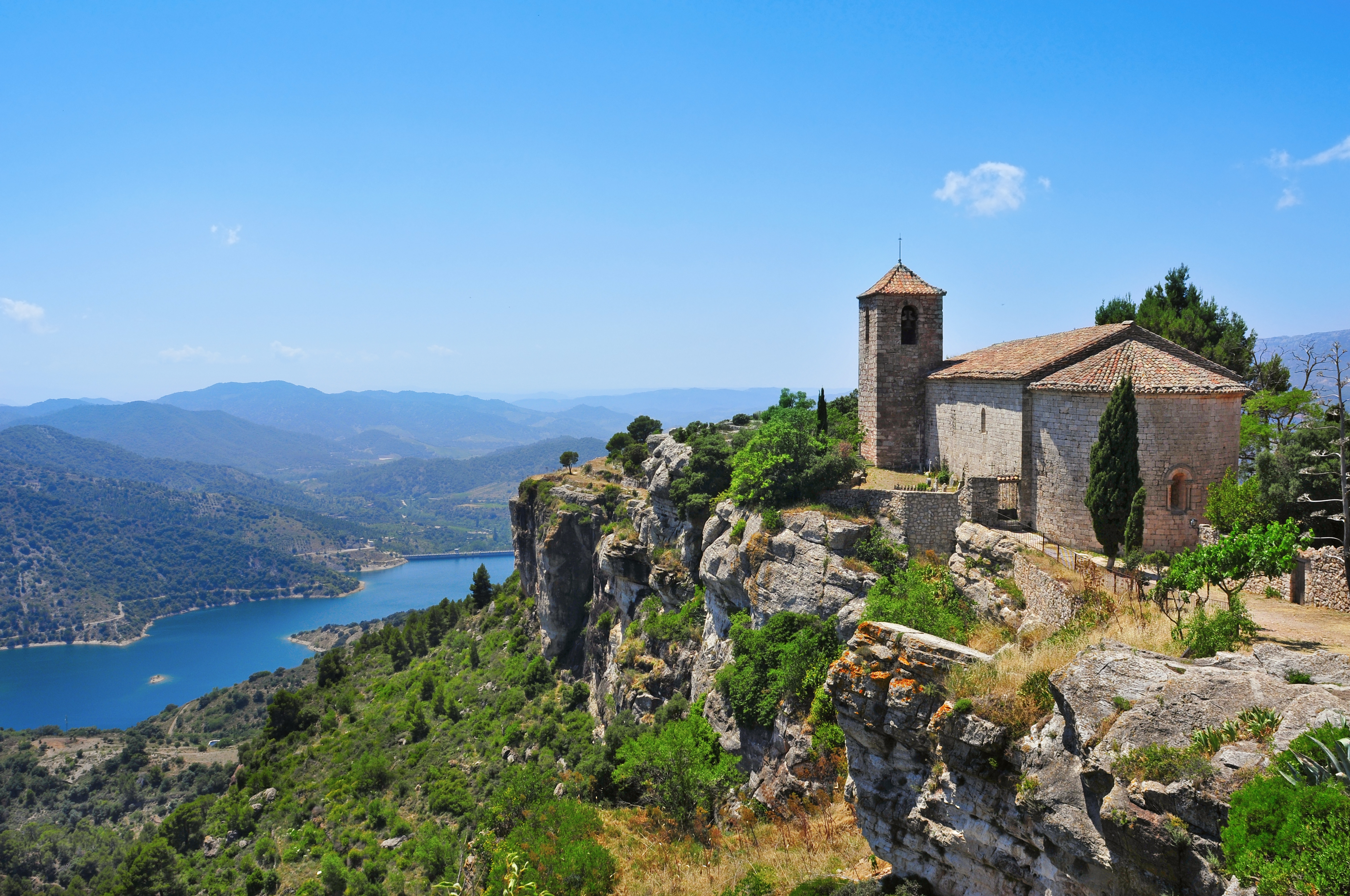 a view of santa maria de siurana church on the top of a peak in siurana spain