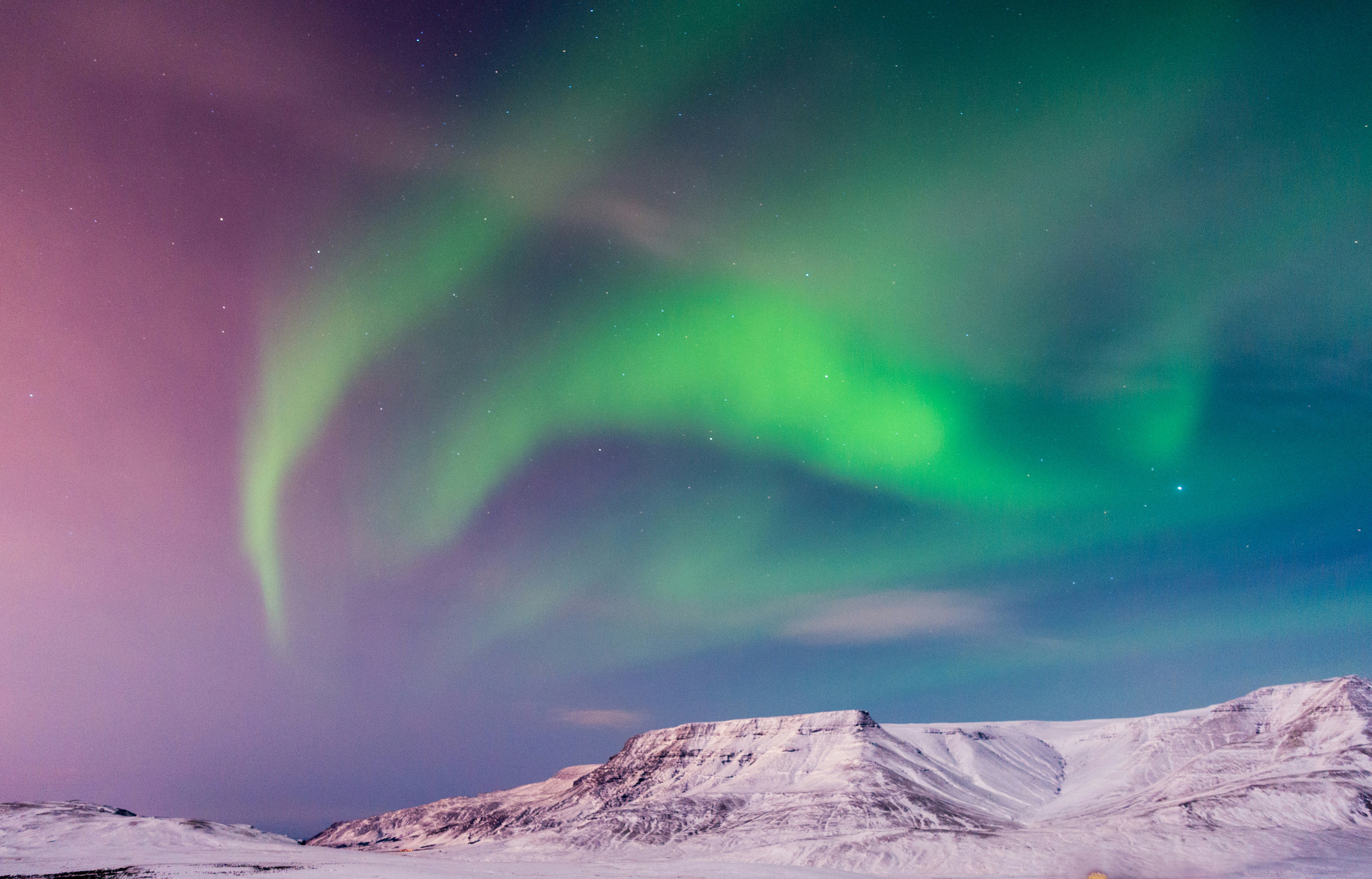 beautiful winter view of reykjavik iceland and the northern lights and auroras with snowcapped mountains